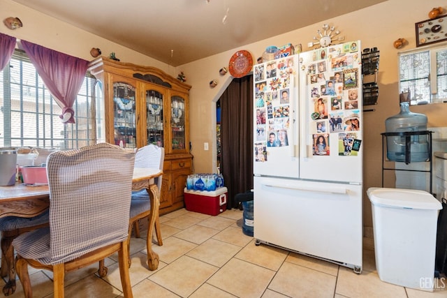 dining space featuring light tile patterned flooring