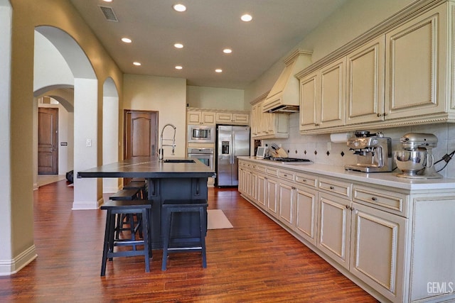 1881 Richert Ave, Clovis, CA 93611 - kitchen with stainless steel appliances, arched walkways, cream cabinets, recessed lighting, and tasteful backsplash