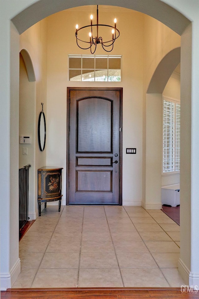 1881 Richert Ave, Clovis, CA 93611 - foyer featuring arched walkways, a chandelier, plenty of natural light, and tile patterned floors