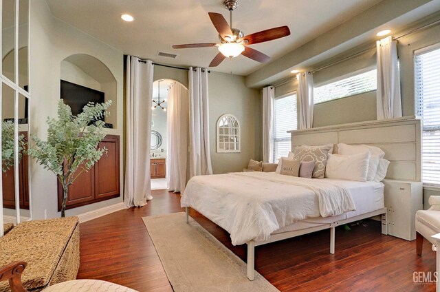 1881 Richert Ave, Clovis, CA 93611 - bedroom featuring arched walkways, dark wood finished floors, recessed lighting, a ceiling fan, and ensuite bath