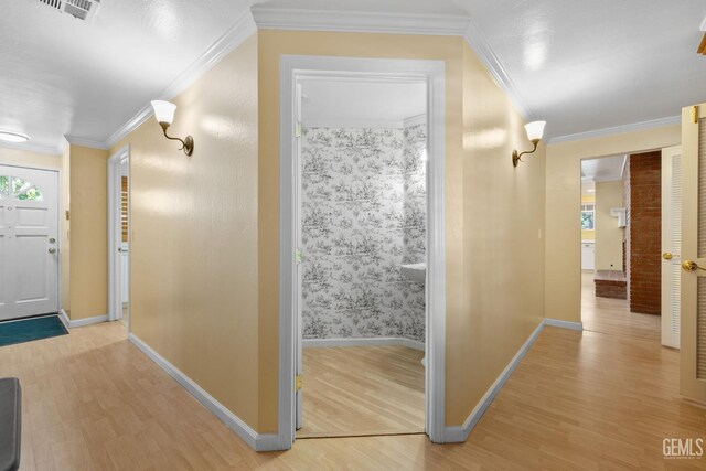 1191 Edmund St, Bakersfield, CA 93309 - hallway with light wood finished floors and ornamental molding