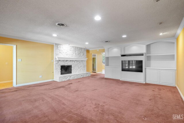 1191 Edmund St, Bakersfield, CA 93309 - unfurnished living room featuring a stone fireplace, ornamental molding, carpet flooring, recessed lighting, and a textured ceiling