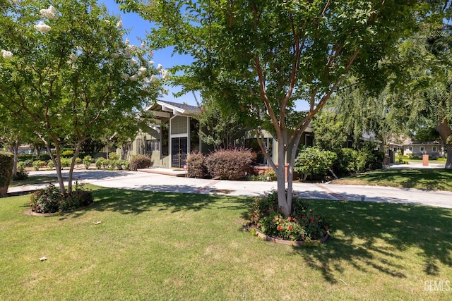1191 Edmund St, Bakersfield, CA 93309 - view of property hidden behind natural elements with a front lawn