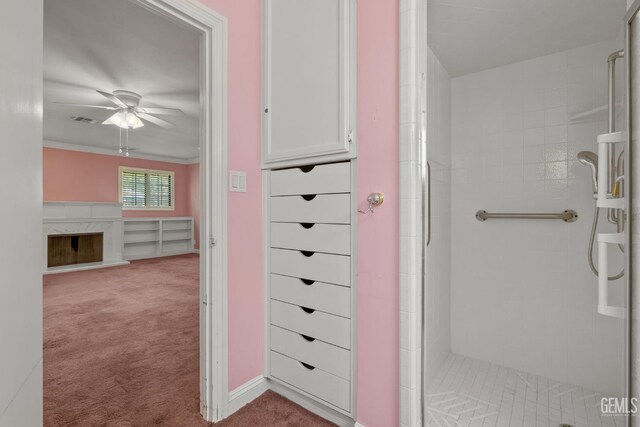 1191 Edmund St, Bakersfield, CA 93309 - bathroom with a shower stall, ceiling fan, a fireplace, and crown molding
