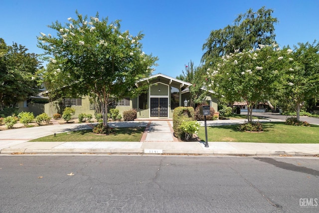 1191 Edmund St, Bakersfield, CA 93309 - obstructed view of property featuring a front lawn