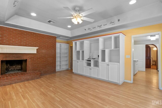 1191 Edmund St, Bakersfield, CA 93309 - unfurnished living room featuring arched walkways, a ceiling fan, a raised ceiling, light wood-style floors, and recessed lighting