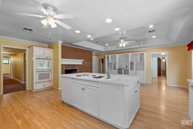 1191 Edmund St, Bakersfield, CA 93309 - kitchen featuring a tray ceiling, a ceiling fan, white double oven, light wood finished floors, and recessed lighting
