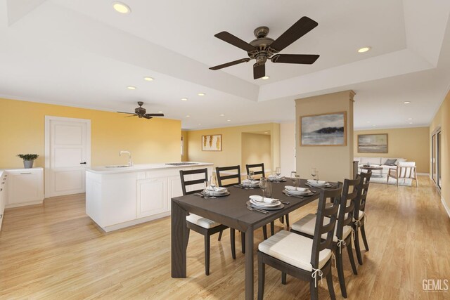 1191 Edmund St, Bakersfield, CA 93309 - dining room with light wood-style flooring, ceiling fan, a tray ceiling, and recessed lighting