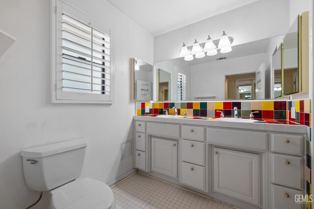 1191 Edmund St, Bakersfield, CA 93309 - bathroom with double vanity, tile patterned floors, and tasteful backsplash