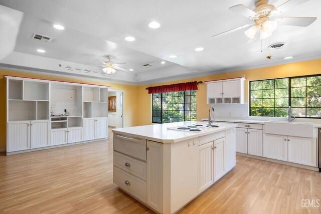 1191 Edmund St, Bakersfield, CA 93309 - kitchen with a ceiling fan, light wood-type flooring, a warming drawer, a raised ceiling, and recessed lighting