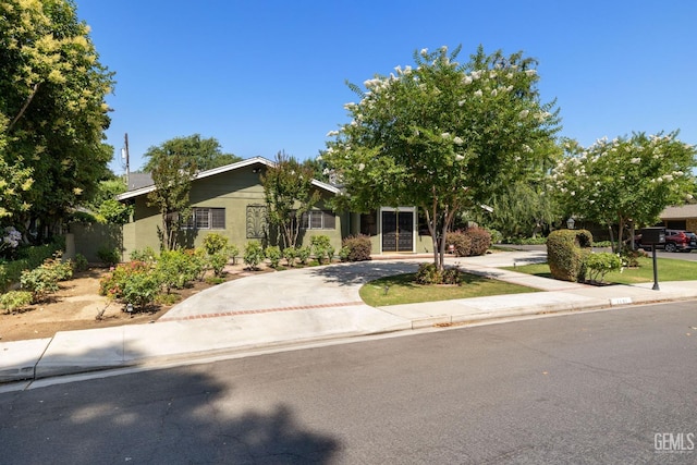 1191 Edmund St, Bakersfield, CA 93309 - view of front of house with curved driveway and stucco siding