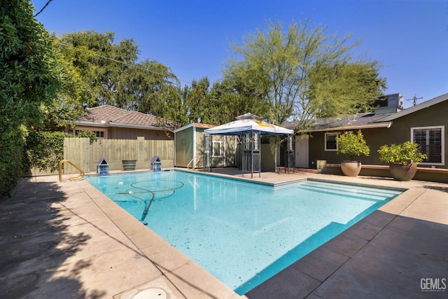 1191 Edmund St, Bakersfield, CA 93309 - view of pool with a patio area and a storage shed