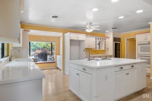 1191 Edmund St, Bakersfield, CA 93309 - kitchen featuring beverage cooler, a ceiling fan, light wood-style flooring, ornamental molding, and recessed lighting
