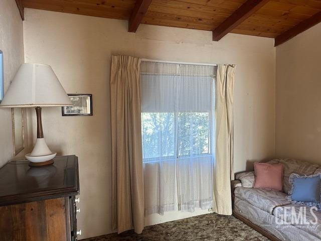 sitting room with beam ceiling and wooden ceiling