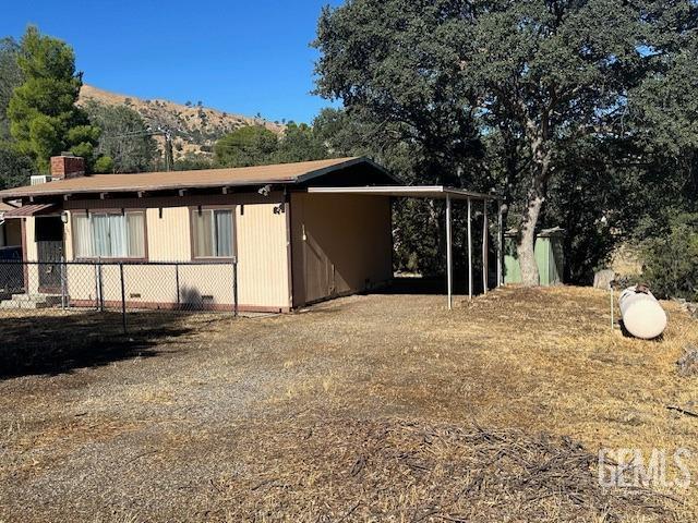 view of side of home featuring a mountain view and a carport