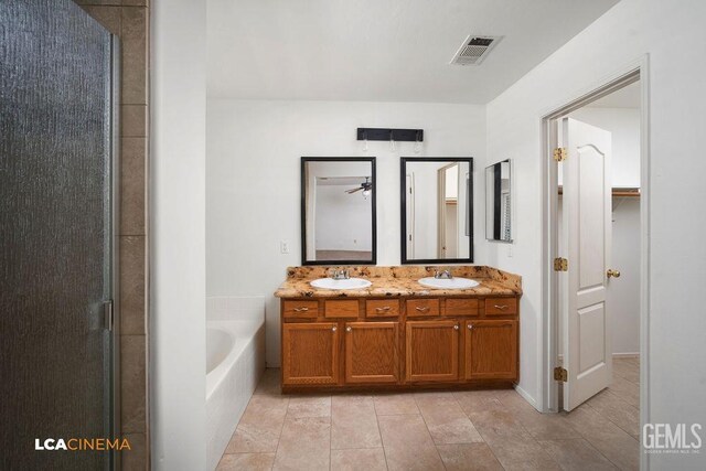 5605 Meadow Valley Ct, Bakersfield, CA 93312 - bathroom with tile patterned flooring, a garden tub, double vanity, and an enclosed shower