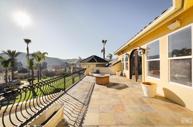 view of patio / terrace featuring a mountain view and an outdoor fire pit