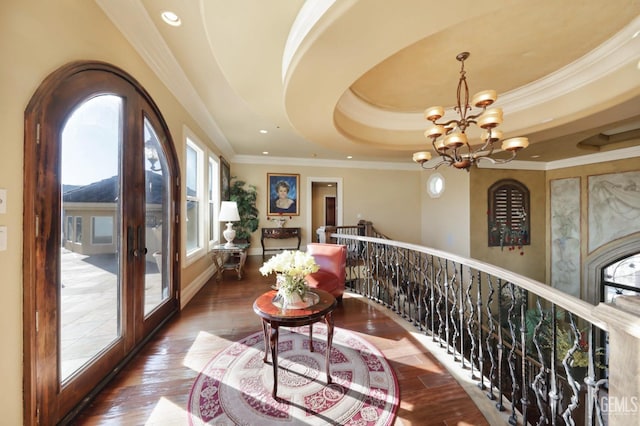 hallway featuring french doors, dark hardwood / wood-style flooring, and a raised ceiling