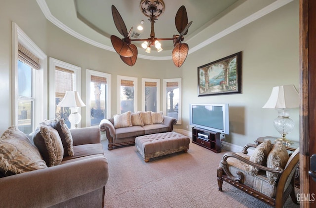 living room with ceiling fan, crown molding, carpet, and a raised ceiling