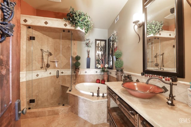 bathroom featuring vanity and shower with separate bathtub