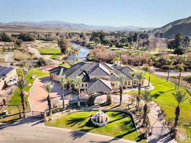 birds eye view of property with a water and mountain view