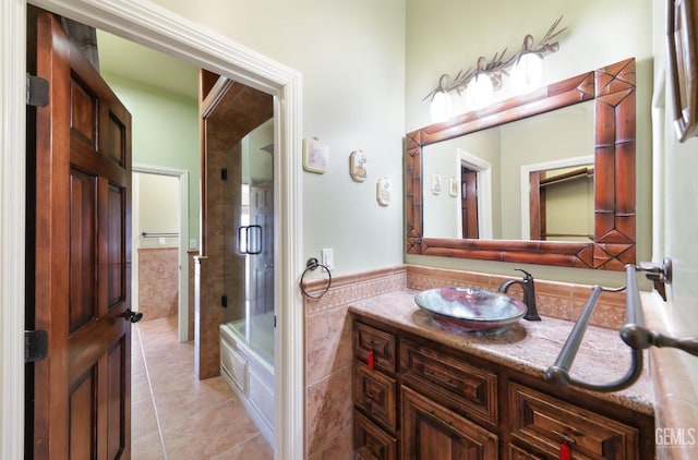 bathroom with tile patterned floors, vanity, and shower / bath combination with glass door