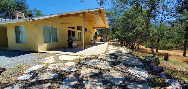 rear view of property featuring a patio