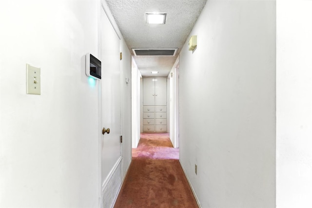 700 Mulberry St, Tehachapi, CA 93561 - hallway featuring a textured ceiling and carpet flooring