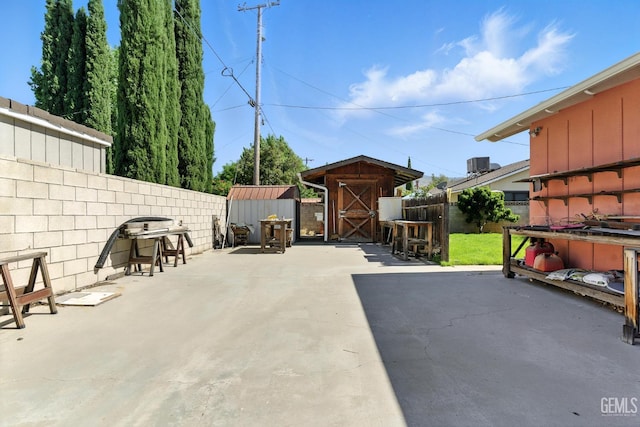 700 Mulberry St, Tehachapi, CA 93561 - fenced backyard featuring a storage unit and a patio