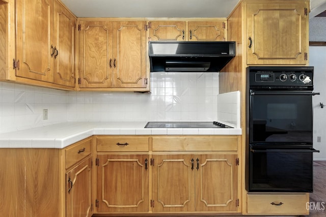 700 Mulberry St, Tehachapi, CA 93561 - kitchen with black appliances, range hood, backsplash, and tile counters