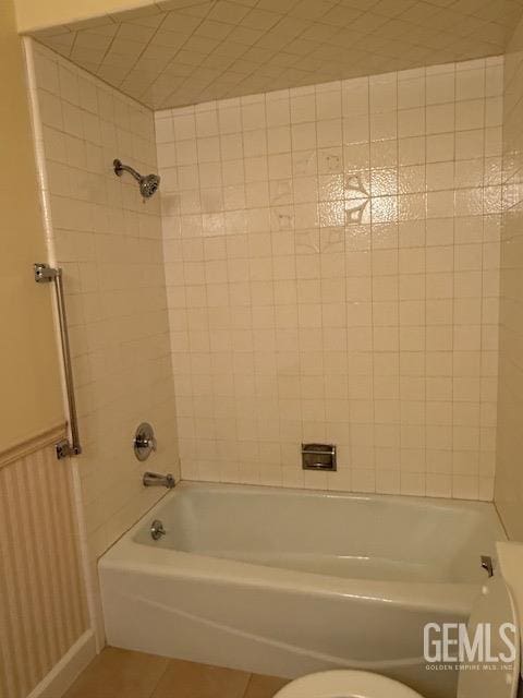 bathroom with tile patterned flooring, toilet, and shower / tub combination