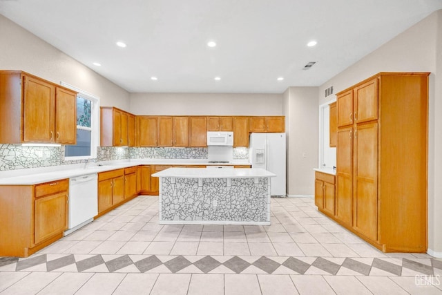 kitchen with backsplash, a center island, and white appliances