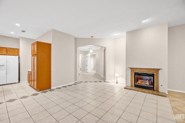 unfurnished living room featuring light tile patterned floors