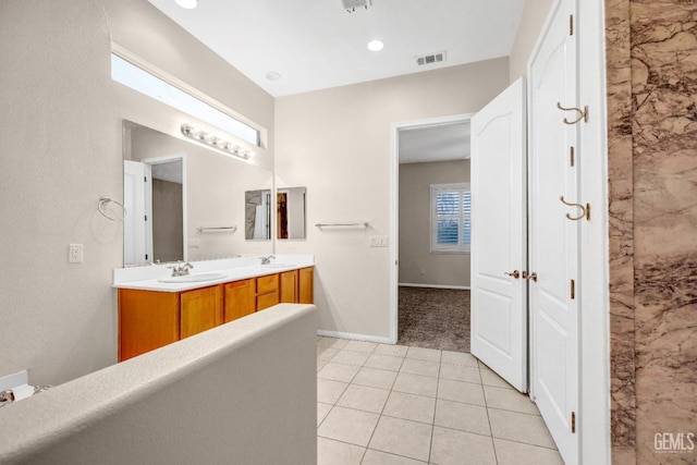 bathroom with tile patterned flooring and vanity