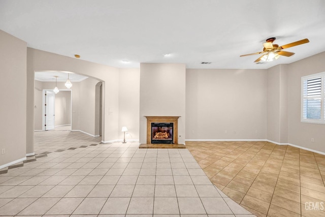 unfurnished living room featuring ceiling fan and light tile patterned floors