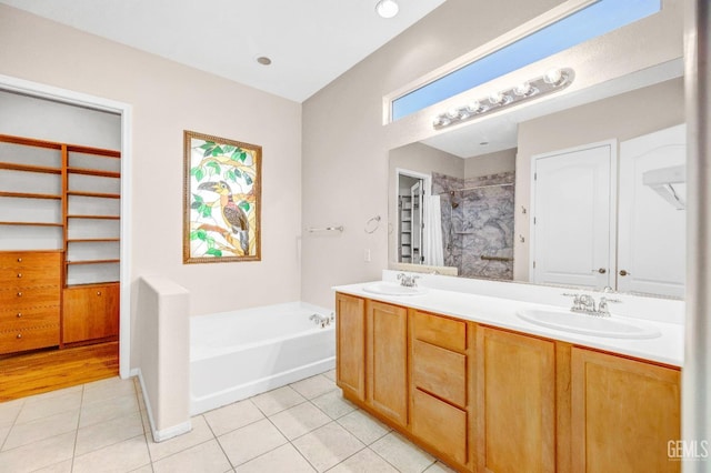 bathroom with tile patterned floors, vanity, and plus walk in shower