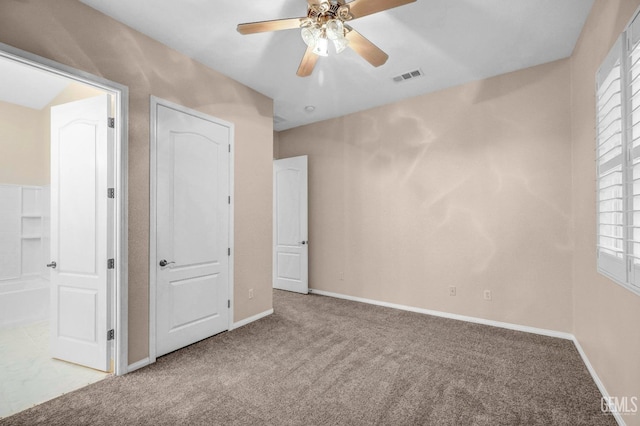 unfurnished bedroom with carpet, ceiling fan, and multiple windows