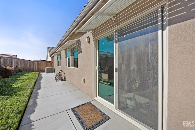 view of patio / terrace featuring central AC unit and fence