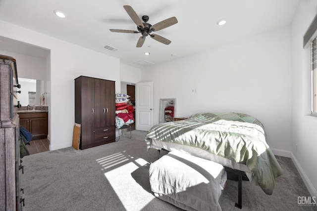 bedroom featuring light carpet, a sink, visible vents, and recessed lighting