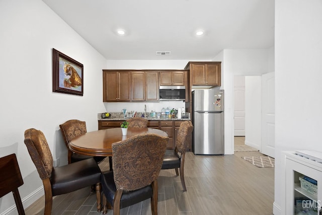 dining area with recessed lighting, visible vents, baseboards, and wood finished floors