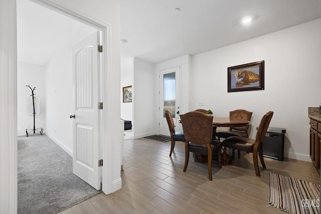 dining area featuring light wood-style floors and baseboards