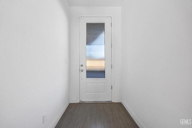 doorway to outside featuring dark wood-style floors and baseboards