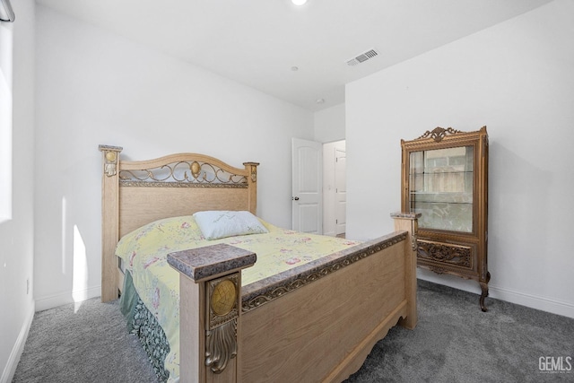 bedroom featuring visible vents, dark carpet, and baseboards