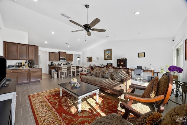 living room with lofted ceiling, recessed lighting, dark wood-style flooring, visible vents, and a ceiling fan