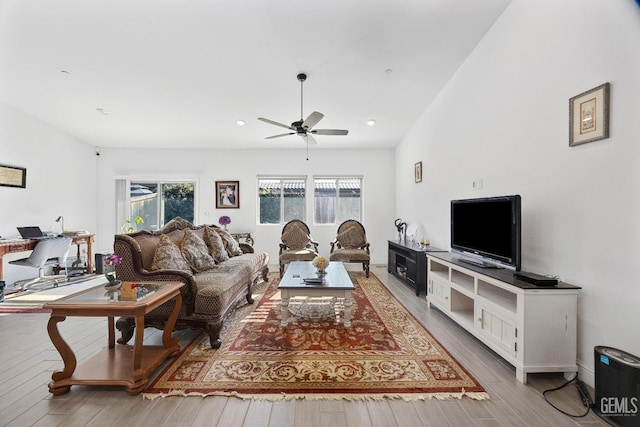 living room with light wood-type flooring, ceiling fan, and recessed lighting