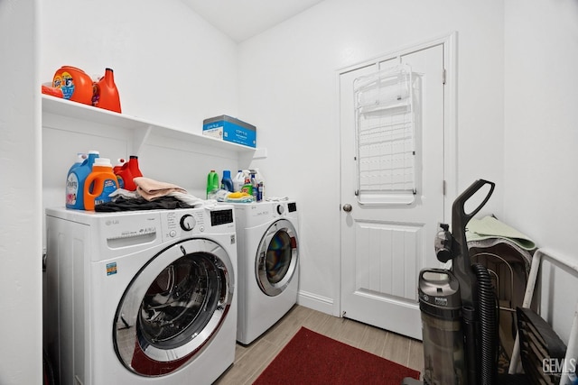 washroom with laundry area, wood tiled floor, and washer and dryer