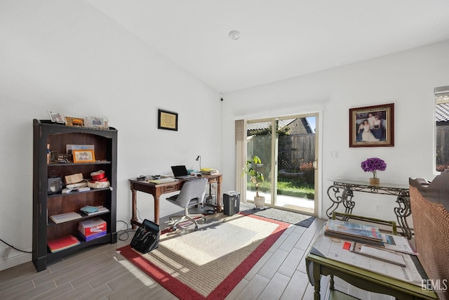 office space with wood tiled floor and vaulted ceiling