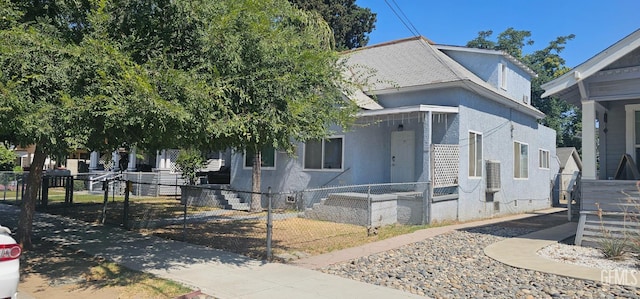 1822 Maple St, Bakersfield, CA 93304 - view of front of home featuring stucco siding, a fenced front yard, and roof with shingles