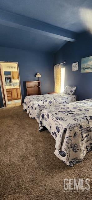 carpeted bedroom with beamed ceiling