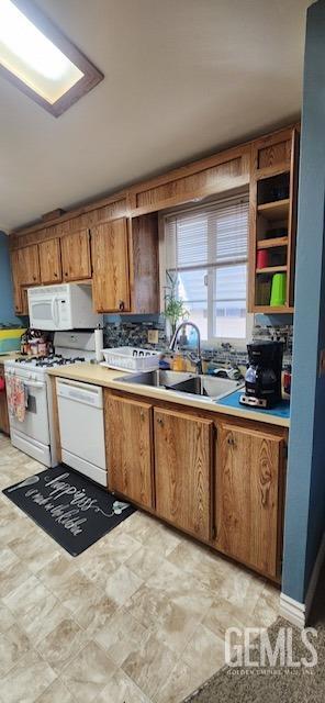 kitchen with white appliances and sink